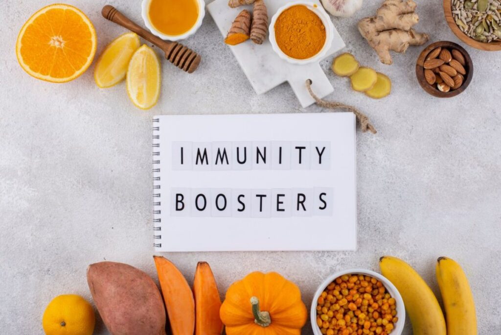 Variety of natural foods displayed as immunity boosters, including oranges, honey, turmeric, and nuts on a gray background.